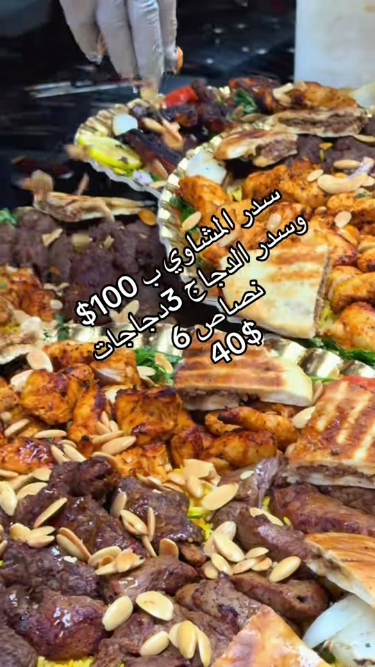 A mixed grill feast — grilled chicken, kebabs, and flatbread spread on one tray